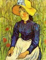 Joven campesina con sombrero de paja sentada frente a un campo de trigo Vincent van Gogh